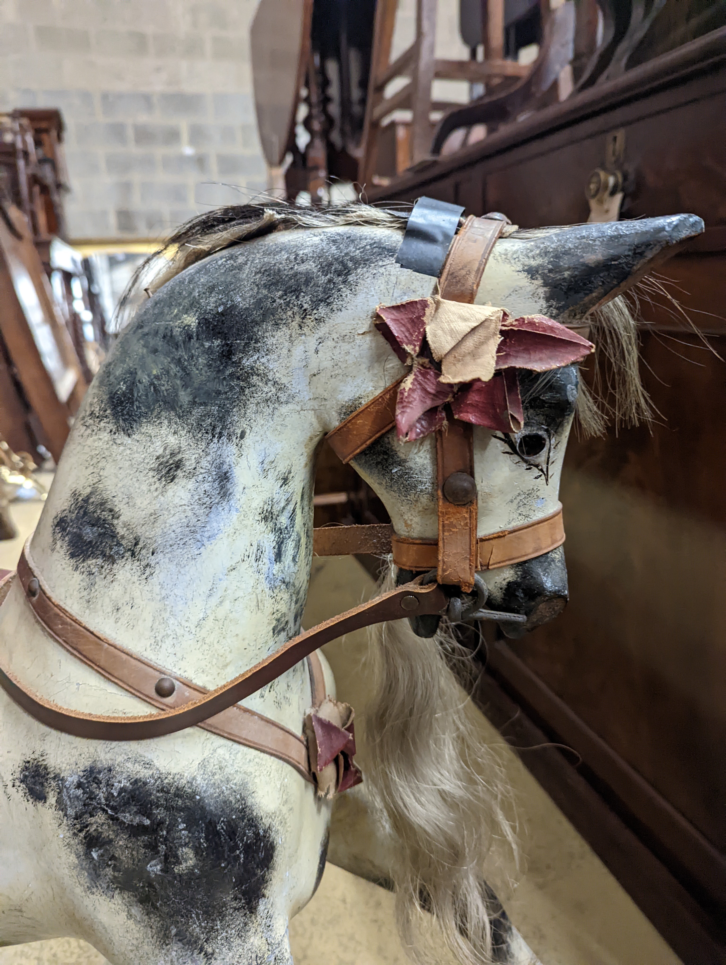 A Victorian carved and painted wood rocking horse, lacking underframe, length 77cm and two painted wood hobby horses, 58cm and 38cm